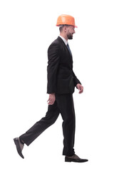 side view.smiling businessman in a helmet going forward