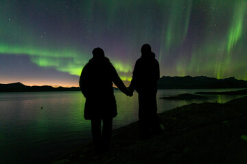 silhouette of a couple watching  Aurora Borealis