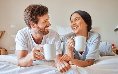 Couple coffee, interracial smile and relax on bed in house, smile for love marriage and funny...