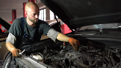 Fototapeta na wymiar Auto mechanic repairs car engine. car service. close-up.
