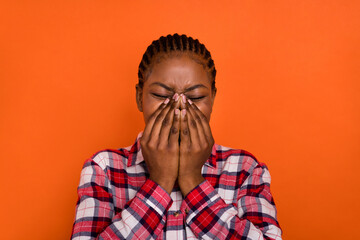 Photo of young person arms covering mouth sneezing cough isolated on orange color background