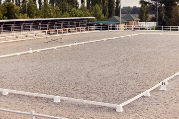 Empty riding sand arena of a horse farm. Concept of sport, competition