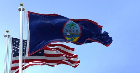 Flag of Guam waving in the wind with the US flag on a clear day