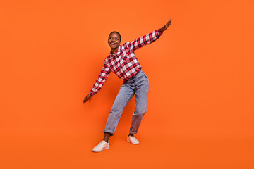 Fototapeta na wymiar Full length photo of cheerful nice person dancing chilling spend pastime isolated on orange color background