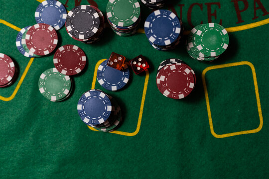 Gambling, Fortune, Game And Entertainment Concept - Close Up Of Casino Chips On Green Table Surface