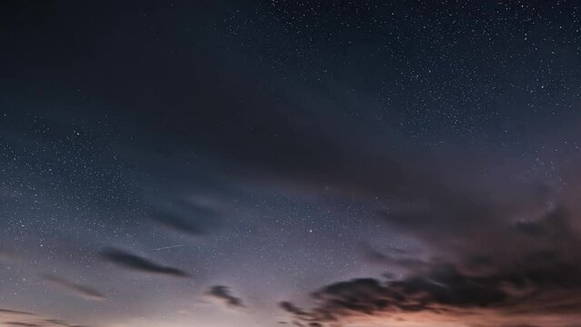 Background of Dark starry night sky with stars and clouds motion fast Time lapse