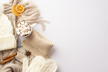 Fototapeta na wymiar Winter concept. Top view photo of knitted pullover scarf hat mittens cup of cocoa with marshmallow dried orange slices anise and cinnamon sticks on isolated white background with copyspace