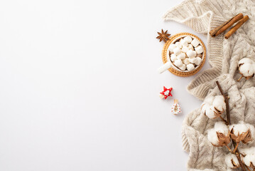 Winter concept. Top view photo of mug of cocoa with marshmallow rattan placemat knitted scarf decorative wooden clips cotton branch anise cinnamon sticks on isolated white background with empty space
