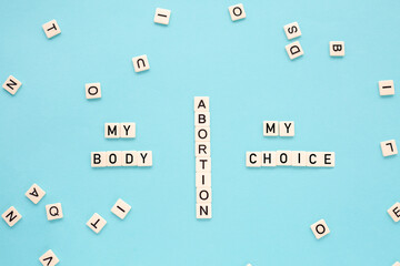 The word abortion, my body, my choice on a blue background. Reproductive rights.Flat lay