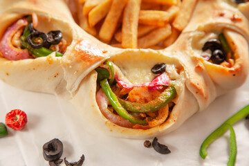 Chicken fajita stuffed bread naan with potato chips fries extreme closeup.