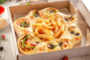 Chicken fajita stuffed bread naan with potato chips fries in a delivery box.