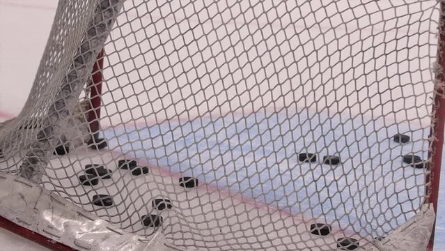 Ice Hockey cinematic slow motion footage of goals net hit by puck. Player Hitting Puck with stick scores goal missed by Goalie. Stylish Cinematic Close-up, Dramatic Lighting, 1000 fps Slow Motion Shot