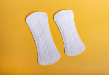 Menstrual pads on orange background