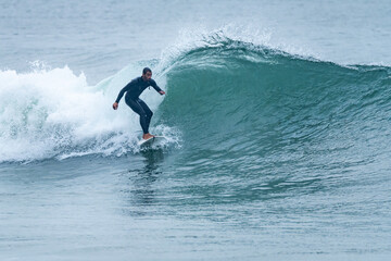 Surfing on turquoise wave in ocean