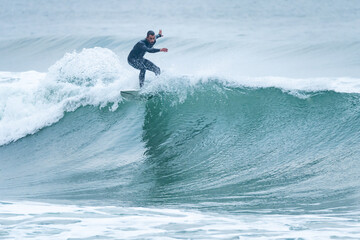 Surfing on turquoise wave in ocean