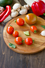 Fototapeta na wymiar Few Cherry tomatoes on a wooden board