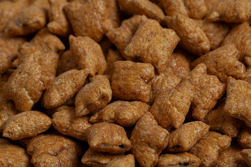 Chocolate pillows close up. Breakfast cereals isolated on white background.