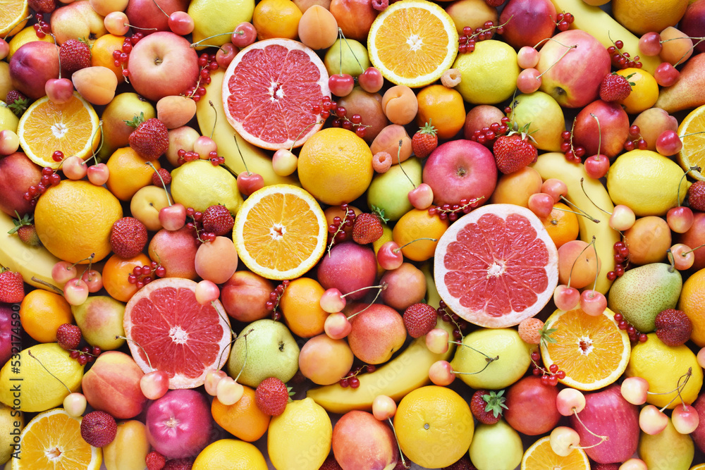 Wall mural Fresh ripe organic fruits from market: pear and orange, grapefruit and lemon, apricot and berries, apple and banana