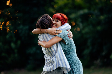 Happy lesbian girls, being in a big hug, sharing love while bein