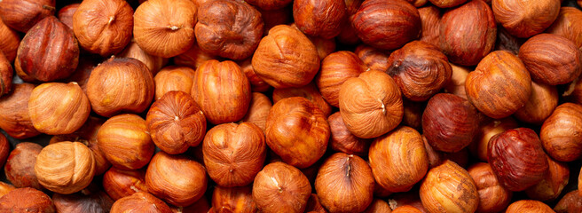 Heap of hazelnuts close-up. Peeled nuts. Hazelnut isolated on white background.