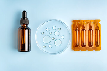 Set of plastic ampoules with dropper bottle and petri dish with drops of oil. Cosmetic laboratory...