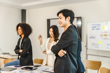 Multiracial business team on a meeting in a modern bright office, Diverse colleagues working on project together, sitting at table in boardroom.