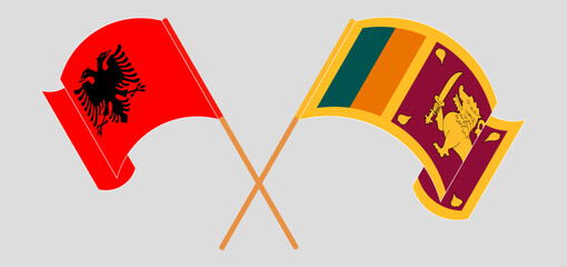 Crossed and waving flags of Albania and Sri Lanka
