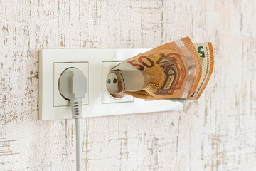 socket and switch in the wall. the euros are in it. tariff growth. saving electricity