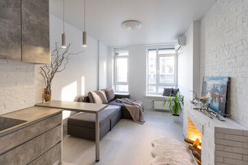studio in minimalist style, fireplace, sofa