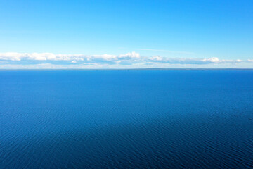 Aerial view of a crystal clear sea water texture. View from above Natural blue background. Blue...