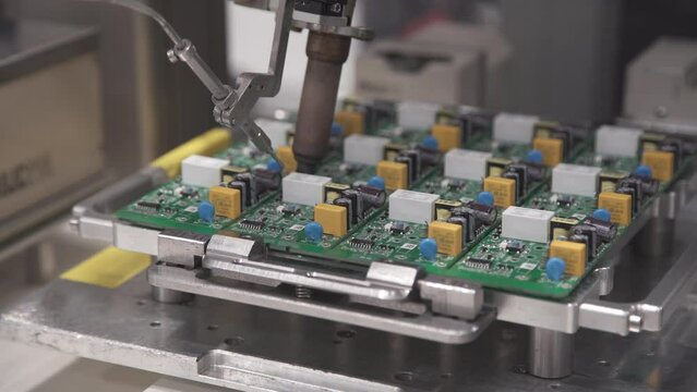 Automatic soldering machine soldering components to the board. Soldering Robot.