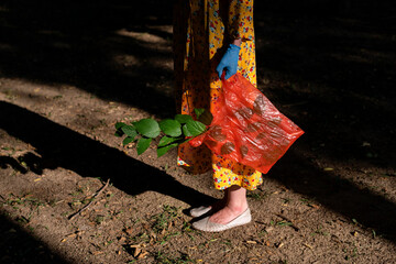 Woman holding plastic bag and green leaves. Ecology concept