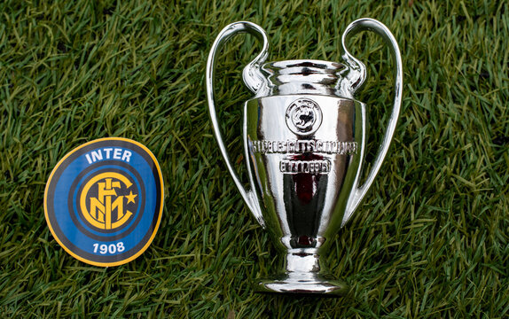 April 21, 2021, Moscow, Russia. The emblem of the football club Inter Milan and the UEFA Champions League cup on the green grass of the stadium.