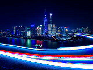 Nightscape of Lujiazui skyline with light trails from the Bund, Shanghai, China.