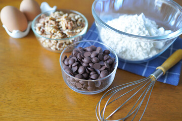mixed ingredient, flour, eggs, chocolate chips and walnut prepare for baking cake or cookie.