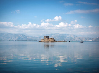 Fototapeta na wymiar View of old Venetian fortress and old prison, Bourtzi at the sea. Argolis bay, Nafplio - Greece