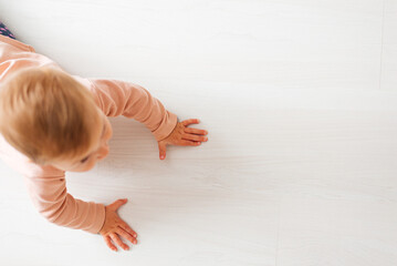 baby on wood floor learning to crawl