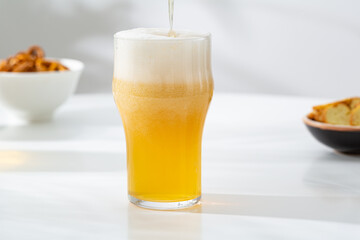 Close up of light craft beer pouring in glass refreshment beverges
