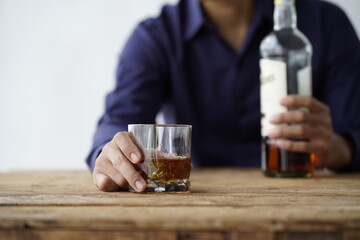 Businessman handshake after make deal, alcoholism, alcohol addiction and people concept - male alcoholic with glass of whiskey lying or sleeping on table 