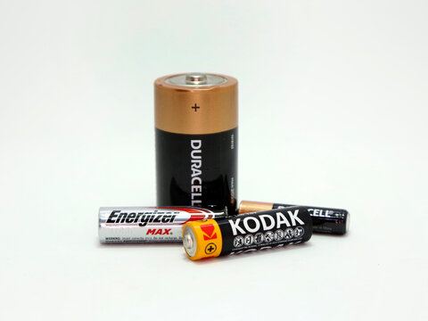 Batteries. Alkaline batteries. Single use batteries. Disposable batteries of brands Duracell, Kodak, Energizer. Isolated white. Different sizes AAA, AA, D. Technology. Energy. Battery.