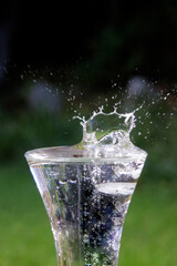 Ice splashing into glass of Iced Water