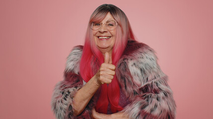 Like. Stylish elderly granny woman raises thumbs up agrees with something or gives positive reply...