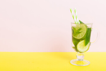 Mojito summer refreshing cocktail with ice and mint. mojito cocktail with lime, lemon and mint in a tall glass with a stick