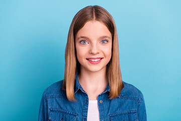 Fototapeta premium Photo of teenager blond girl wear jeans jacket isolated on blue color background