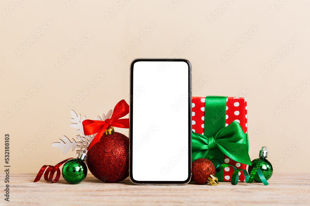 Wall mural digital phone mock up with rustic christmas decorations for app presentation with empty space for yo