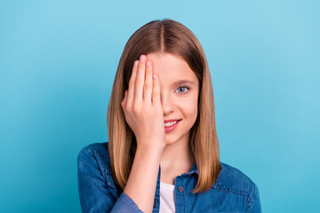 Photo of lovely teen blond girl close eye wear jeans shirt isolated on blue color background