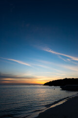 Fototapeta premium Golden sunset and dark blue sky with silhouette island and sea vertical style at Thailand