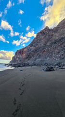 Scenic view during sunset on the volcanic sand beach Playa del Ingles in Valle Gran Rey, La Gomera,...