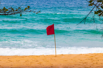 Naithon Beach bay red flag turquoise clear water Phuket Thailand.