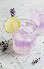 Lemonade with lime and lavender on gray marble background